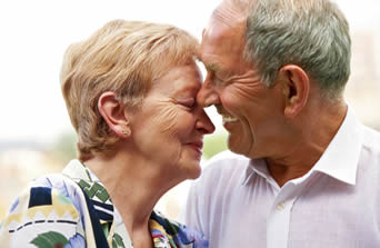 elderly couple smiling with Medicare/Medi-Cal Planning assistance